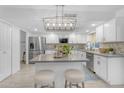 Bright kitchen featuring white cabinets, stainless steel appliances, an island, and stylish lighting at 1917 E Karen Dr, Phoenix, AZ 85022