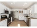 Modern kitchen with stainless steel appliances, granite countertops, and white cabinetry at 2112 S 160Th Dr, Goodyear, AZ 85338