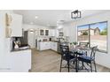 Modern kitchen with white cabinets, granite countertops, and a cozy breakfast nook at 2112 S 160Th Dr, Goodyear, AZ 85338