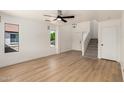 Open living room with wood floors, bright windows, and staircase to the second floor at 2112 S 160Th Dr, Goodyear, AZ 85338