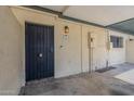 The entrance features a secured door and classic lighting with a security door at 2223 E Catalina Dr, Phoenix, AZ 85016