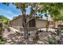 Single-story home with desert landscaping, including cacti and agave plants, and a well-maintained yard at 22670 N Kennedy Dr, Maricopa, AZ 85138