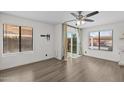 Well-lit bedroom with wide windows, wood flooring, and sliding glass door to a patio at 2455 E Broadway Rd # 122, Mesa, AZ 85204