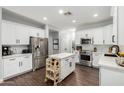 Bright, white kitchen with a large island, stainless steel appliances, and modern finishes at 25210 N 40Th Ave, Phoenix, AZ 85083