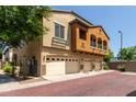 Exterior view of townhomes showing the well-maintained exteriors, garages, and neighborhood setting at 2727 N Price Rd # 32, Chandler, AZ 85224