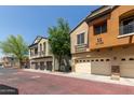Exterior view of townhomes with two-car garages, showcasing the neighborhood's aesthetic and curb appeal at 2727 N Price Rd # 32, Chandler, AZ 85224