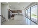 Open concept kitchen with island, stainless appliances, and sliding glass doors to backyard at 3451 S Wren Dr, Gilbert, AZ 85297