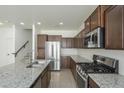 Modern kitchen with stainless steel appliances, granite countertops, and tile flooring at 3451 S Wren Dr, Gilbert, AZ 85297