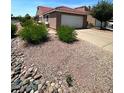 Single-story home with a red tile roof, gravel landscaping, and an attached two-car garage at 3510 E Hampton Ave # 133, Mesa, AZ 85204