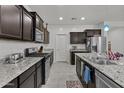 Well-equipped kitchen with stainless steel appliances, granite countertops, and ample cabinet space for storage and functionality at 37103 N El Morro Trl, San Tan Valley, AZ 85140