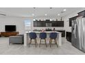 Modern kitchen boasting granite countertops, stainless steel appliances, and a breakfast bar, enhancing convenience at 37103 N El Morro Trl, San Tan Valley, AZ 85140