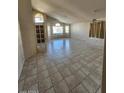 Spacious living room featuring tile flooring, high ceilings, large windows, and ample natural light at 3853 W Calle Lejos --, Glendale, AZ 85310