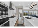 Bright, modern kitchen with stainless steel appliances, a large island, and opens to the living area at 3915 N Shannon Cir, Mesa, AZ 85215