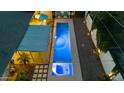 Aerial view of the backyard, highlighting the modern pool, patio, and lush landscaping creating a private oasis at 421 N Evergreen St, Chandler, AZ 85225