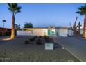 Charming mid-century modern home featuring a neatly landscaped front yard, stylish exterior, and well-lit pathway at 421 N Evergreen St, Chandler, AZ 85225