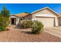 Inviting single-story home featuring a well-manicured front yard and a two-car garage at 4251 E Sundance Ave, Gilbert, AZ 85297