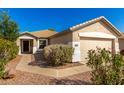 Inviting single-story home showcasing a well-manicured front yard and a two-car garage at 4251 E Sundance Ave, Gilbert, AZ 85297