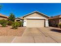 Single-story home with a two-car garage and desert landscaping providing curb appeal at 4251 E Sundance Ave, Gilbert, AZ 85297