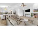 Spacious living room open to the kitchen, with modern furnishings, a fireplace, and a large-screen television at 4301 E Abraham Ln, Phoenix, AZ 85050