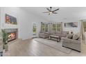Inviting living room with a fireplace, comfortable seating, and large windows overlooking the backyard at 4301 E Abraham Ln, Phoenix, AZ 85050