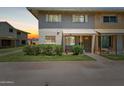 Charming townhome featuring a well-maintained front lawn, covered porch, and neutral brick facade at 4629 S Mill Ave, Tempe, AZ 85282