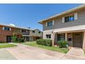 Charming townhouse featuring a well-maintained lawn, mature shrubs, brick facade, and covered front porch at 4629 S Mill Ave, Tempe, AZ 85282