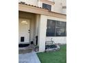 Inviting front entrance featuring a cream door with a half moon window and a small pet door at 4743 W Alice Ave, Glendale, AZ 85302