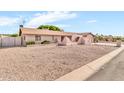 Single-story home featuring desert landscaping and a charming, light pink exterior paint at 6055 E Hannibal St, Mesa, AZ 85205