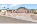 Single-story home with arched entry, two-car garage, and desert landscaping at 6055 E Hannibal St, Mesa, AZ 85205