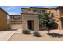 A two-story home with a tile roof, front-facing garage, desert landscaping, and stucco exterior at 6388 W Ruth Ave, Glendale, AZ 85302