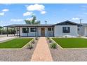 Inviting single-story home with manicured lawn, stylish exterior paint, and appealing front entrance at 6908 E Windsor Ave, Scottsdale, AZ 85257