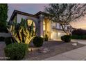 Attractive two-story home with desert landscaping, a three-car garage, and arched windows at 7247 W Buckskin Trl, Peoria, AZ 85383