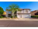 Attractive two-story stucco home with a three-car garage and low-maintenance desert landscaping at 7247 W Buckskin Trl, Peoria, AZ 85383