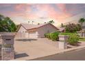 A three-car garage is accessed from a spacious driveway with great curb appeal at 7722 W Michigan Ave, Glendale, AZ 85308