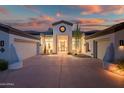 Eye-catching front exterior with symmetrical curb appeal and a circular window above the front door at 7775 E Fledgling Dr, Scottsdale, AZ 85255