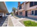 Exterior view of a condo with well-maintained landscaping and covered parking at 8111 W Wacker Rd # 94, Peoria, AZ 85381