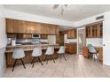Eat-in kitchen with lots of wooden cabinets and breakfast bar at 1004 E Gemini Dr, Tempe, AZ 85283