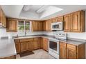 Bright kitchen with light-colored cabinets, white appliances, and tile floors at 1004 E Gemini Dr, Tempe, AZ 85283