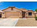 Charming single-story home with a two-car garage, desert landscaping, and a well-maintained front yard at 10934 W Almeria Rd, Avondale, AZ 85392