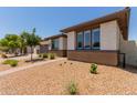 Well-maintained single-story home showcasing desert landscaping and a paved walkway to the entrance at 1166 W Silver Creek Ln, Queen Creek, AZ 85140