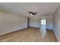 Open-concept living room featuring vinyl flooring and a ceiling fan at 14002 N 38Th St, Phoenix, AZ 85032