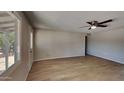 Comfortable living room area featuring vinyl flooring, ceiling fan and access to backyard at 14002 N 38Th St, Phoenix, AZ 85032