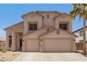 Two-story home with a neutral color palette, a two-car garage, and desert landscaping in the front yard at 14099 W Riviera Dr, Surprise, AZ 85379