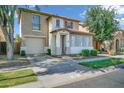 Charming two-story home featuring a neutral color scheme, attached garage, and well-maintained landscaping at 1420 E Sonrisas St, Phoenix, AZ 85040