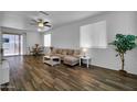 Bright living room featuring wood-look floors, neutral walls, and an open layout at 1420 E Sonrisas St, Phoenix, AZ 85040