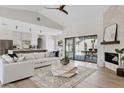 Open living space with a stylish sofa, hardwood floors, and a view of the outdoor dining area at 14401 N 60Th Pl, Scottsdale, AZ 85254