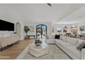 Spacious living room with a plush sofa, modern furniture, and large windows for natural light at 14401 N 60Th Pl, Scottsdale, AZ 85254