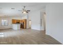 Open floor plan featuring spacious living area and kitchen with stainless appliances at 15853 N 74Th Ave, Peoria, AZ 85382