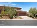 Exterior view of a home with desert landscaping, driveway, and an attached garage at 16364 E Ridgeline Dr, Fountain Hills, AZ 85268