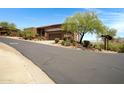 Exterior view of a home with desert landscaping, driveway, and an attached garage at 16364 E Ridgeline Dr, Fountain Hills, AZ 85268
